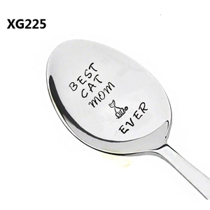 Macro shot of stainless steel spoon featuring laser-engraved Best Cat Mom Ever and cat icon
