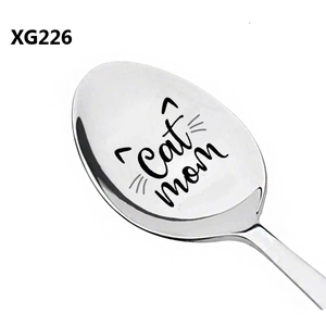 Macro detail of silver stainless steel spoon with laser engraved Cat mom text and ears
