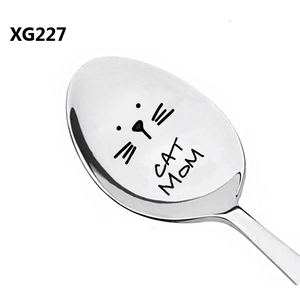 Detail view of a polished stainless steel spoon featuring laser-engraved Cat Mom text
