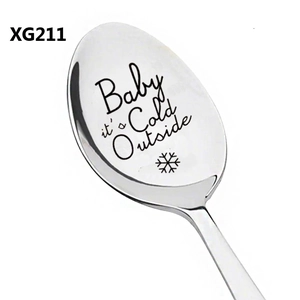 Close-up of polished stainless steel spoon with Baby it's Cold Outside laser engraving