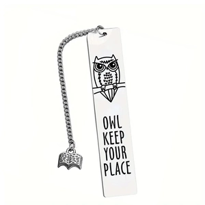 Macro detail of stainless steel owl bookmark with chain and book pendant for readers