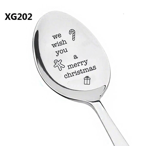 Macro detail of Merry Christmas engraving and festive icons on stainless steel spoon