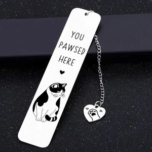Detail showing the stainless steel cat bookmark with heart charm on black background