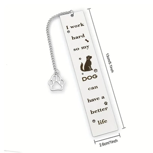 Macro view of stainless steel bookmark with dog quote and a hollow paw charm