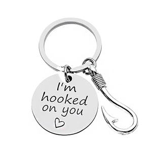 Detailed close-up of stainless steel fish hook keychain with I am hooked on you engraving
