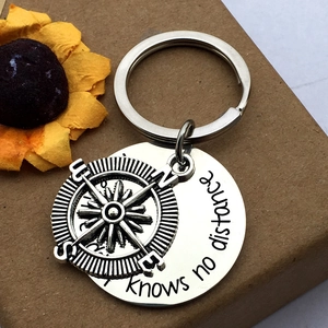 Stainless steel friendship keychain with compass charm and engraved distance quote