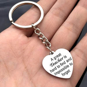 Stainless steel heart keychain for teachers gift held in hand with polished finish