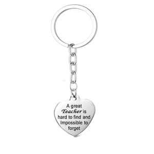 Detail view of heart-shaped stainless steel keychain with engraved teacher appreciation text