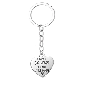 Polished stainless steel teacher heart keychain with motivational engraved text