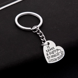 Polished stainless steel heart keychain with teacher appreciation quote on black surface