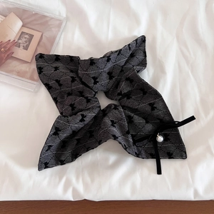 Elegant dark grey vintage velvet bow scrunchie with white pearl pendant on fabric