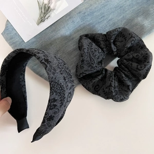 Detail of dark grey paisley wool headband and matching scrunchie set for women