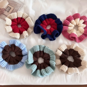 Detailed view of colorful knitted scrunchies set with soft ribbed wool texture