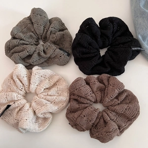 Set of four hollow knit scrunchies in green, black, cream, and coffee colors