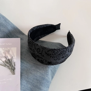 Detail of vintage dark grey paisley wool headband with non-slip inner fabric texture