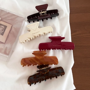 Elegant large acetate hair claws in five colors featuring Barrette La France lettering
