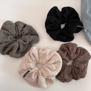 Set of four hollow knit scrunchies in charcoal, dark grey, beige, and coffee brown colors