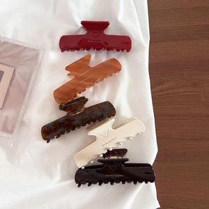 Detailed set of five acetate hair claws in various colors with Barrette La France text