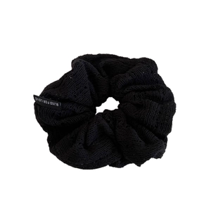 Elegant black knit scrunchie with Blind For Love slogan label for woman hairstyle