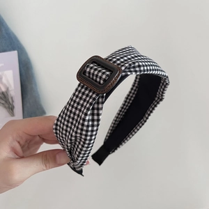 Retro black and white checkered wide headband with brown buckle for a stylish high top look