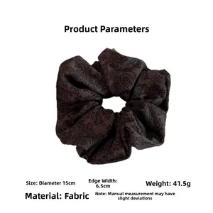 Detailed view of dark brown paisley scrunchie showing 15cm diameter size measurements