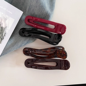 Set of four glossy acetate hair clips in burgundy, black, tortoiseshell and dark purple