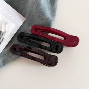 Three large acetate hair clips in burgundy, black, and brown with France Handmade logo