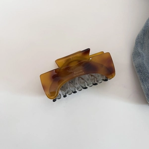 Detail of amber tortoiseshell hair claw with Barrette La France gold lettering text