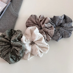 Set of four premium velvet scrunchies in dark green, beige, brown, and grey shades