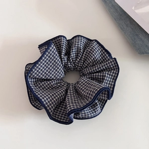 Dettaglio di un elastico in tessuto a quadretti blu e bianchi con trama a più strati
