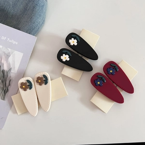 Three pairs of floral acetate water drop hair clips in black, cream, and burgundy colors