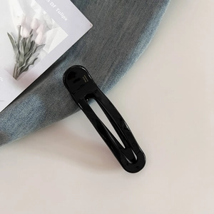 Detail of black glossy acetate hair clip with golden France Handmade engraving