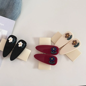 Elegant floral acetate hair clips in black, burgundy, and cream for women's styling