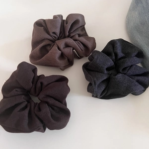 Three premium wool scrunchies in brown and grey fabric shown from top view