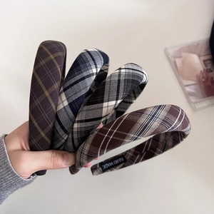 Detail of four plaid padded headbands showing classic patterns and handmade labels