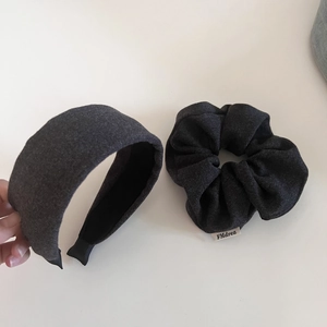 Close-up of deep gray wool texture headband and matching scrunchie with FMdrea tag