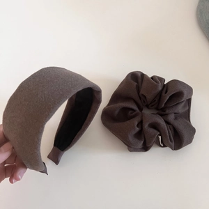 Macro detail of brown fleece hair scrunchie set with soft textured woolen fabric finish