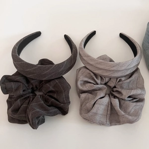Detail of vintage striped fabric headband and matching scrunchie set in gray tones