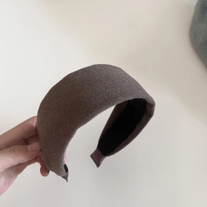 Detailed macro view of dark mocha wool felt wide headband with anti-slip inner lining