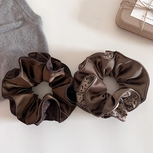 2pcs satin leopard trim hair scrunchies in coffee and khaki on a soft aesthetic background