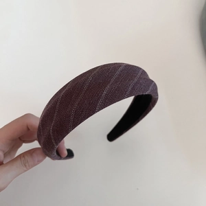 Detail of vintage striped wide headband with premium purple fabric and sponge padding