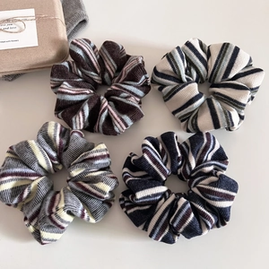 Flat lay of four vintage American style striped knitted hair scrunchies in various colors
