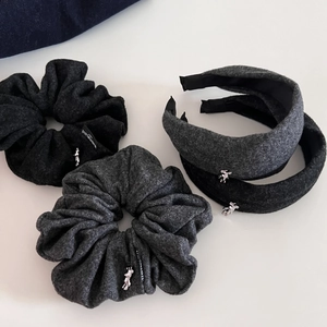 Detail of gray wool hair scrunchies and headbands featuring silver bear pendants