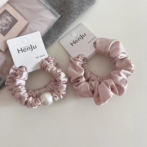 Pink satin hair scrunchies set with pearl detail on elegant minimalist display card