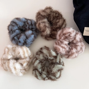 Set of five plush zebra pattern hair scrunchies in soft brown, blue and purple tones