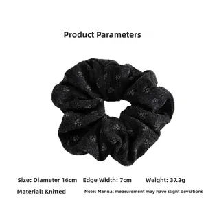 Detail view of large black floral knitted scrunchie with 16cm diameter and 7cm width