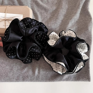 Polka dot satin scrunchies in black and white with four-layer stitching and ruffles