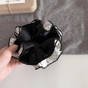 Close-up of double-layered polka dot satin hair scrunchie with detailed stitching