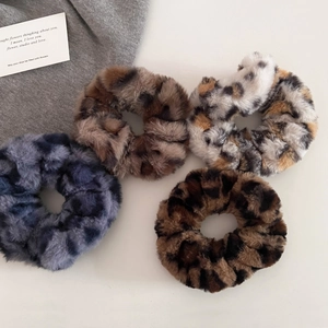 Four-piece set of plush leopard print hair scrunchies in assorted retro autumn colors