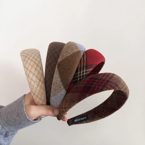 Detail showing five assorted vintage plaid wool headbands with handmade inner labels